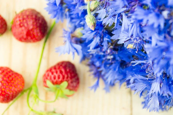 Korenbloemen met aardbeien — Stockfoto