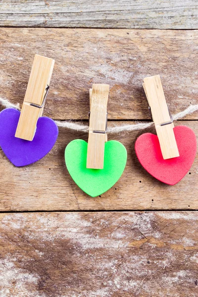 Colored hearts on wooden background — Stock Photo, Image