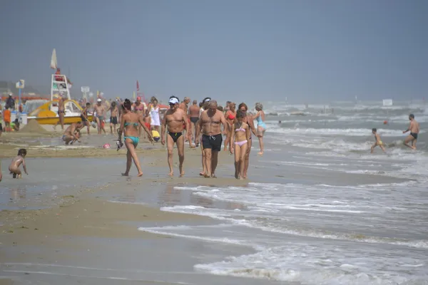 Ludzie spacerów na plaży, w pobliżu morza — Zdjęcie stockowe