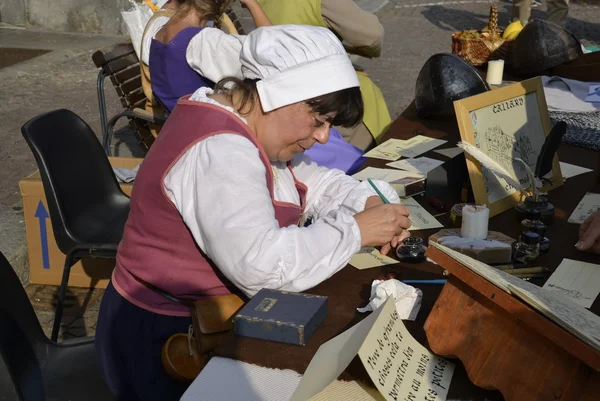 Mulher em roupas vintage escreve em bela caligrafia — Fotografia de Stock
