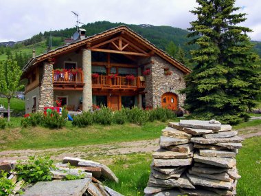 dağ evine. kulübe. sığınak. Pragelato. çatı. çiçekler. taşlar. Yürü. Açık