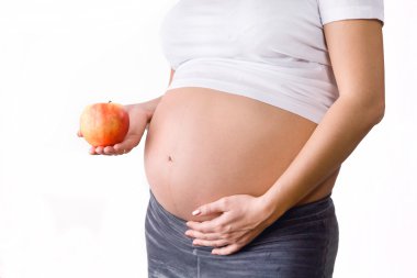 Pregnant woman holding apple