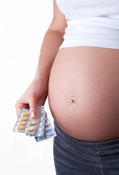 Pregnant woman holding a medical tablets — Stock Photo, Image