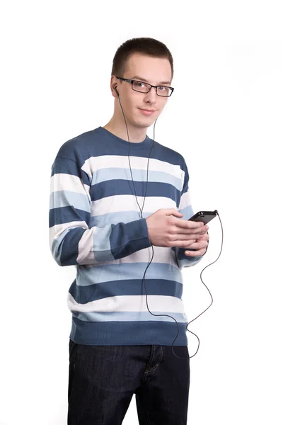 Müzik dinlemek için cep telefonu kullanan genç adam — Stok fotoğraf