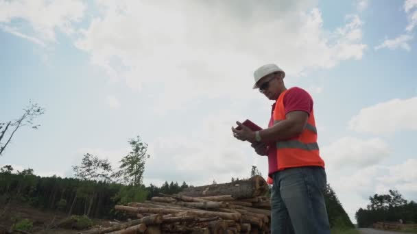 Capataz en el sitio de deforestación toma notas en tableta — Vídeos de Stock