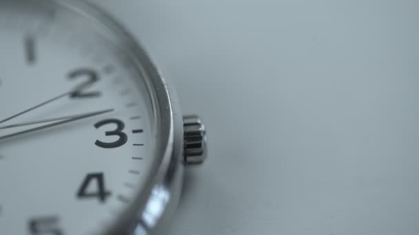 Aged mechanic wrist watch dial with silver arrow on white background — Stock Video