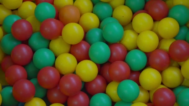 Multi colored plastic balls on children playground pool top view — Stock Video