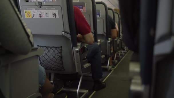 Interior of airplane with passengers on seats waiting to take off — Stock Video