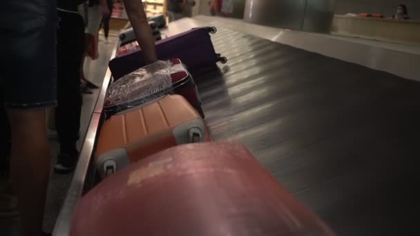 People standing in queue for suitcase or luggage with conveyor belt — Stock Video