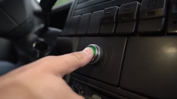 Pushing green power ignition button to start keyless car engine. — Stockvideo