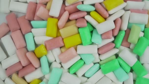 Multicolored bubble gum background rotate view from above. — Vídeo de Stock