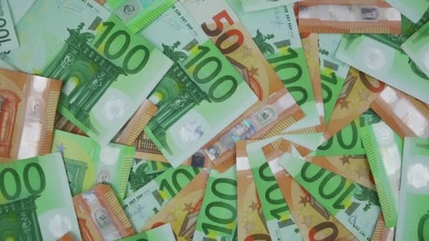 50 and 100 euro money banknotes background rotate top view. — Video Stock