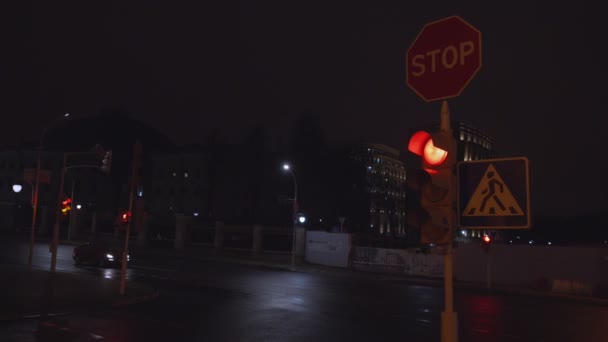 Stop sign and pedestrian crossing signage hanging on street pole — Wideo stockowe