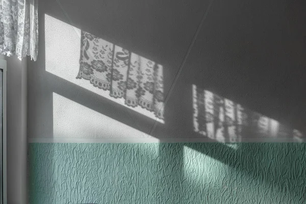 Dark shadow from sunlight illuminated concrete wall through window — Stock Photo, Image