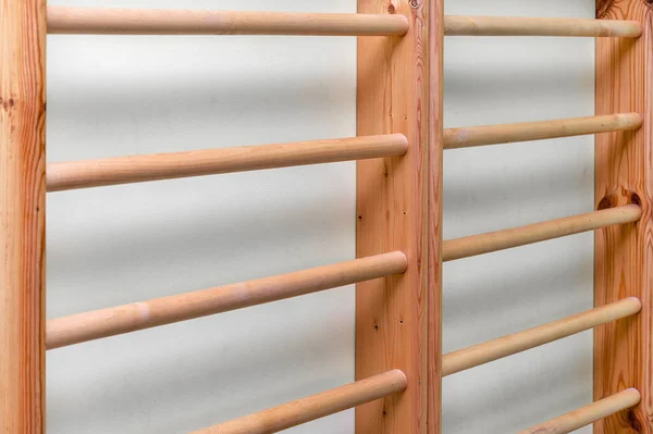 Wooden gymnastics bars ladder in empty gym room of school — Stock Photo, Image