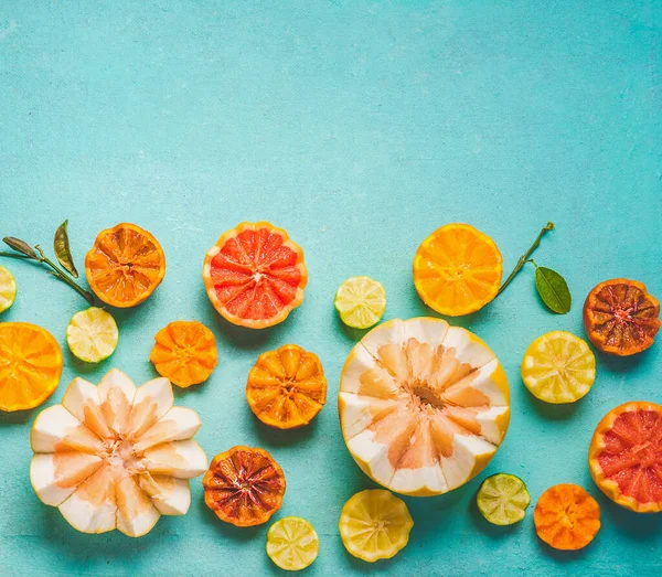 Various Colorful Citrus Fruits Halves Green Leaves Light Blue Background — Stockfoto