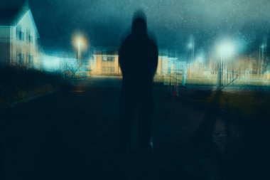 A dark, moody edit of a blurred, ghostly figure standing on a street on a winters night.                        