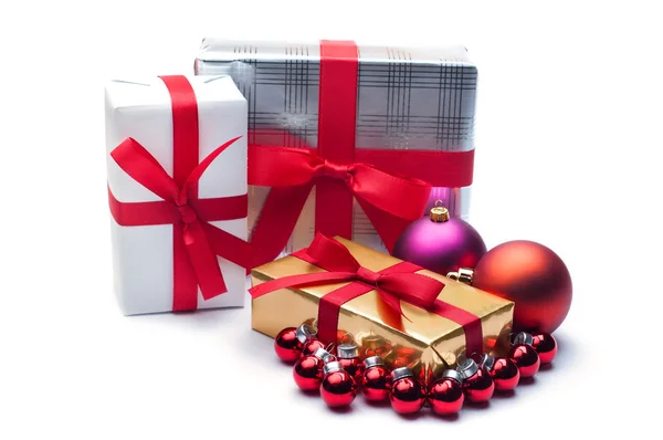 Christmas gifts, with balls. Isolated on white. Royalty Free Stock Images