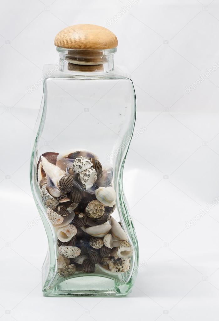 Glass bottle with some seashells