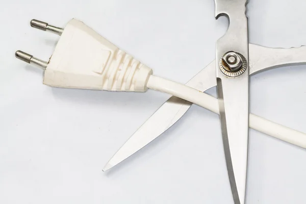 Scissors cutting electric plug — Stock Photo, Image