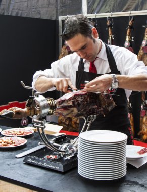 Chef slicing jamon iberico clipart