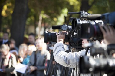 covering an event with a video camera clipart