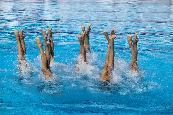 Synchronized swimmers legs movement — Stock Photo, Image