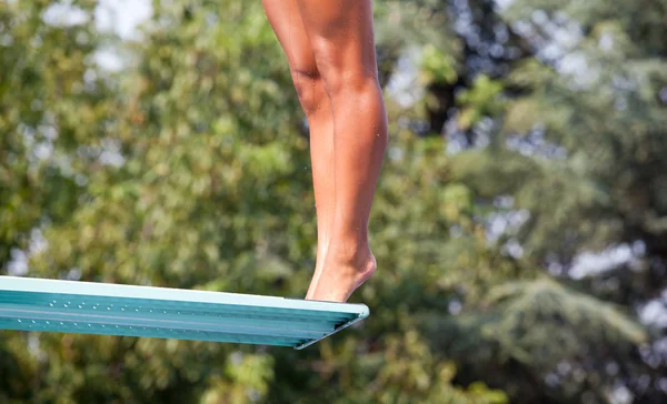 girl standing on diving board