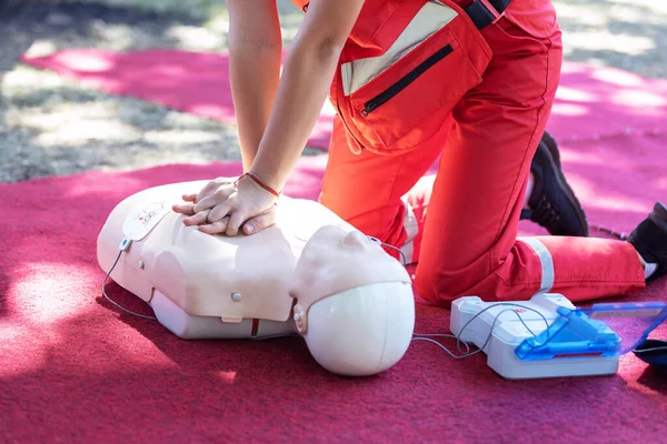 Hands of a paramedic doing chest compression during defibrillator CPR training