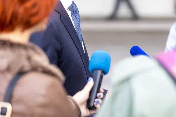 Journalists making media interview with unrecognizable business person or politician