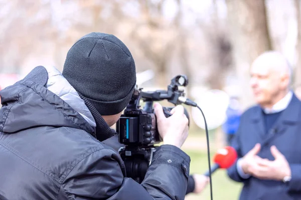 Camera operator filming media interview