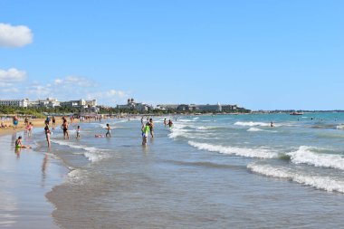 happy vacation on the seaside. people walk along the seashore