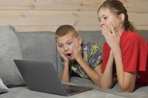 Friendly Children Lie Couch Watching Video Laptop Home Distance Learning — Stockfoto