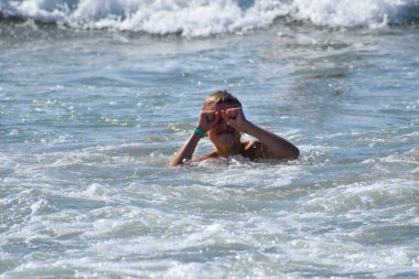 boy in trouble in the water. one boy is drowning in the sea. danger of drowning at sea