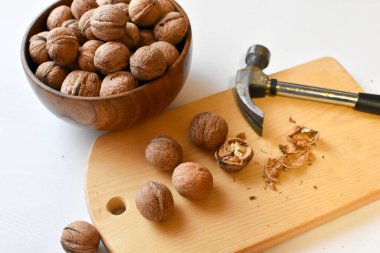 chop the walnuts with a hammer on a cutting board. strong natural walnuts in the kitchen