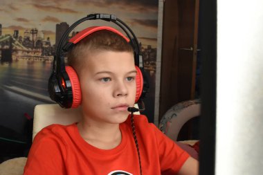 boy is playing an online game on the internet. children's gambling addiction. online learning