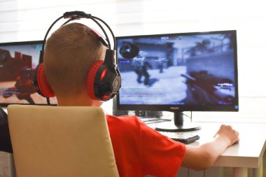 boy is playing an online game on the internet. children's gambling addiction. online learning