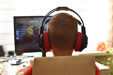 boy is playing an online game on the internet. children's gambling addiction. online learning