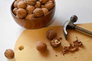 chop the walnuts with a hammer on a cutting board. strong natural walnuts in the kitchen