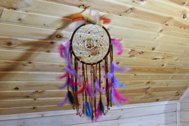 colored handmade dreamcatcher. traditional amulet of the ancient Indians from evil spirits. braided amulet with feathers