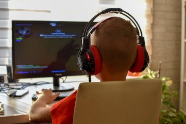 boy is playing an online game on the internet. children's gambling addiction. online learning