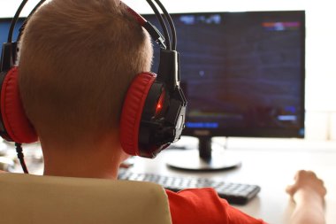 boy is playing an online game on the internet. children's gambling addiction. online learning