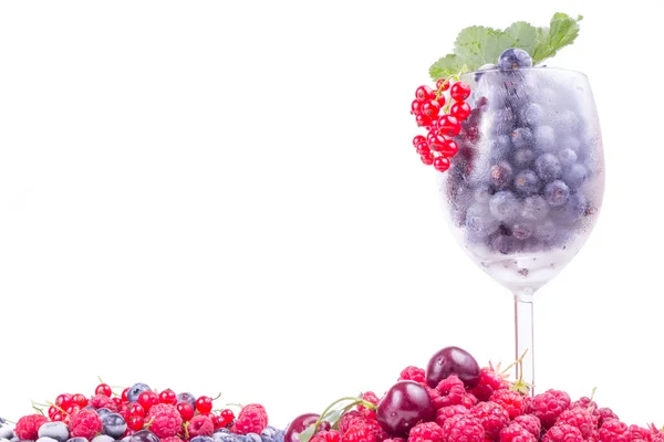 Fresh berries in glass with leaf — Stock Photo, Image