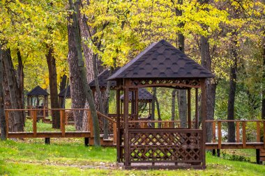 Empty wooden gazebos in a city park on an autumn day no people