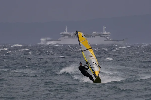 Windsurfer and ferryboat — Stock Photo, Image