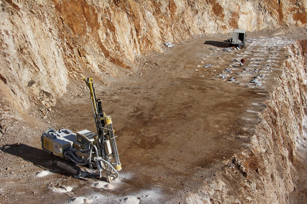 Drilling holes for demolition in a quarry