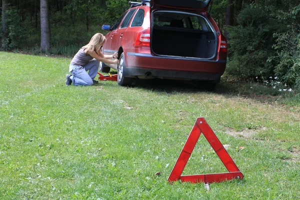 Young blond girl puncture repairs — Stock Photo, Image