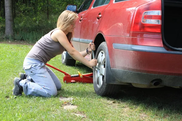 Young blond girl puncture repairs — Stock Photo, Image