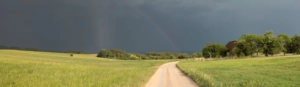summer storm in the country, the sky with rainbow, panorama
