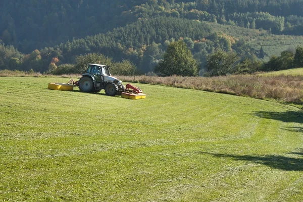 Tractor mowing mountain meadow in Czech Republic — Stock Photo, Image